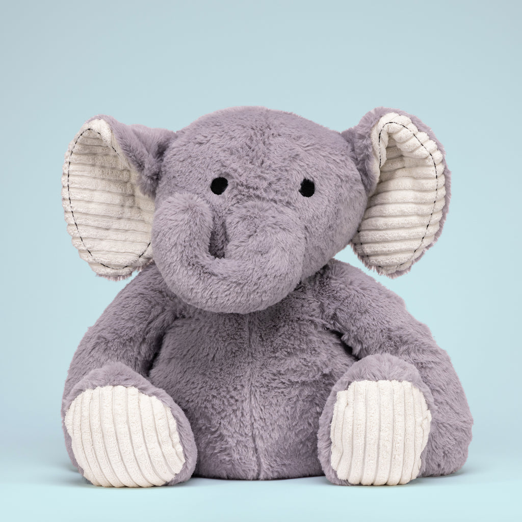 Empowerment Elephant positioned on a blue studio background, emphasizing its sturdy and comforting design.