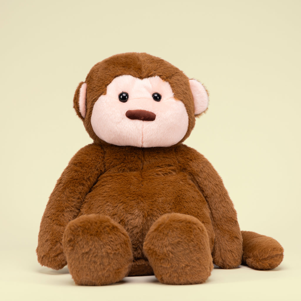 Motivational Monkey featured alone against a yellow studio background, highlighting its cheerful design.