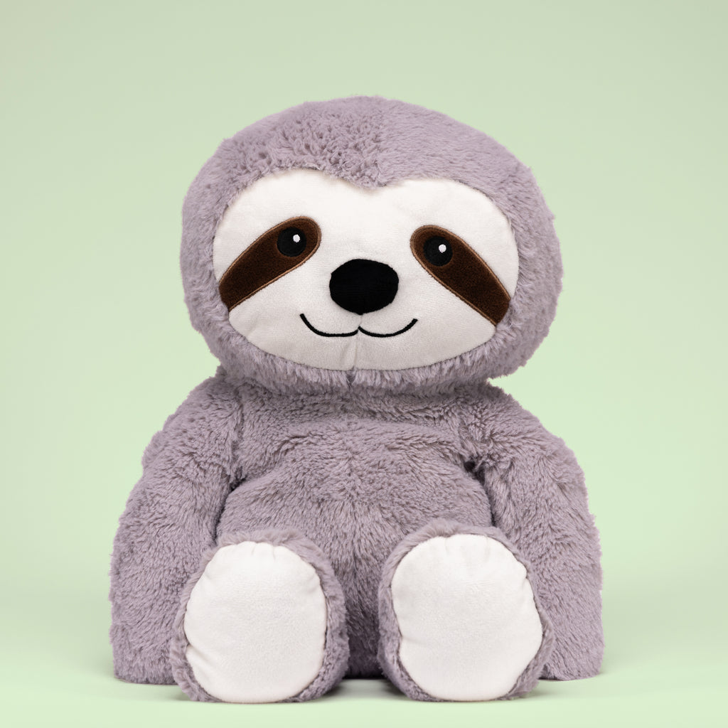 Tranquil Sloth on a green studio background, showcasing its plush gray fabric and serene expression.